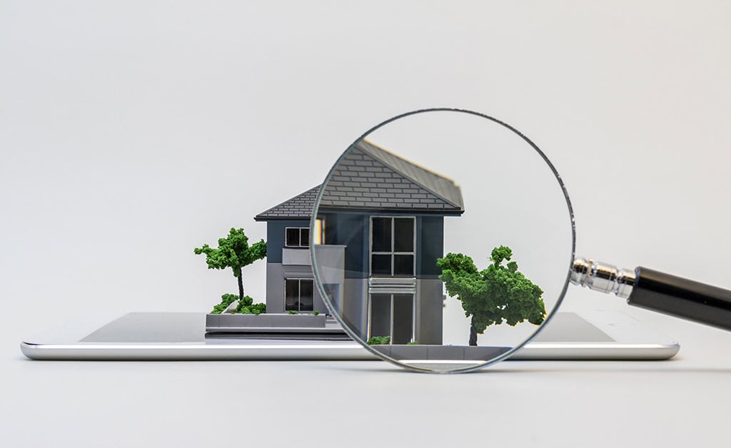 inspection Home inspector examining the exterior of a house before a buyer closes on the property